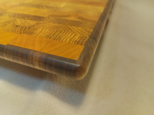 vtw versatile trees woodwork corner view of a thin, large end grain cutting board made with walnut, oak, and cherry. Perfect for a home or professional chef, this board provides a large work area without raising the work surface very far above the counter top