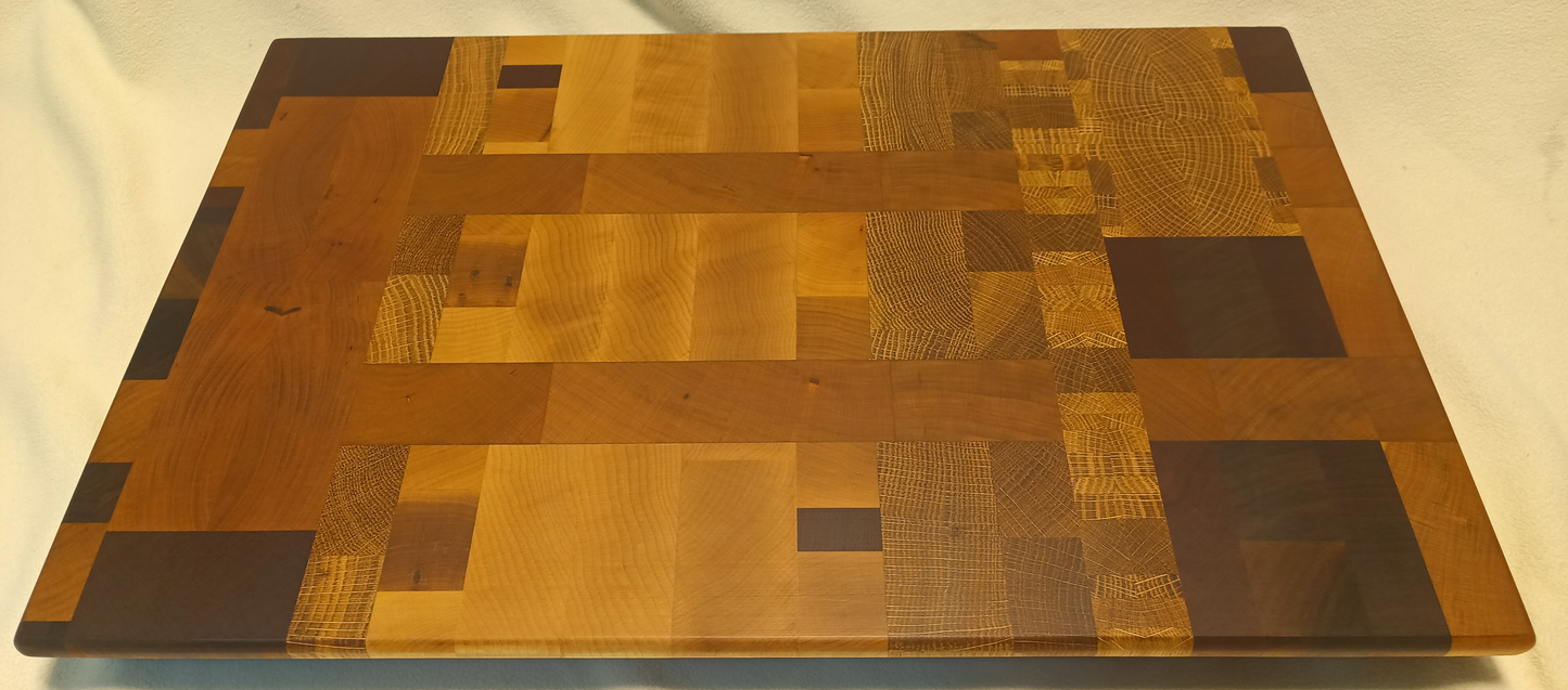vtw versatile trees woodwork main view of a thin, large size end grain cutting board made with walnut, maple, mahogany, oak, and cherry. Perfect for a home or professional chef, this board provides a usable work area without raising the work surface very far above the counter top