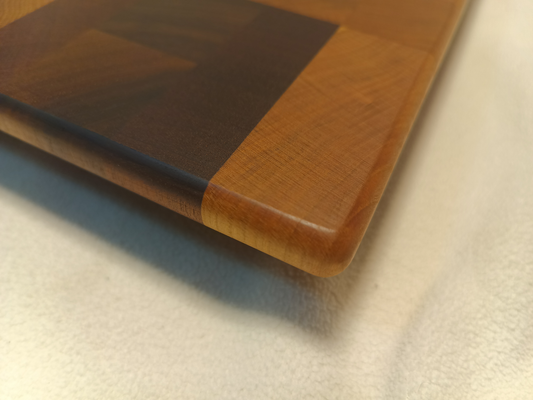 vtw versatile trees woodwork corner view of a thin, large size end grain cutting board made with walnut, hickory, maple, mahogany, and cherry. Perfect for a home or professional chef, this board provides a usable work area without raising the work surface very far above the counter top
